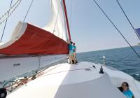 crew hoisting main sail sailing yacht trimaran neel 45